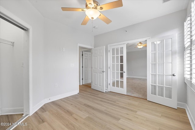 unfurnished room featuring light hardwood / wood-style floors, french doors, and ceiling fan