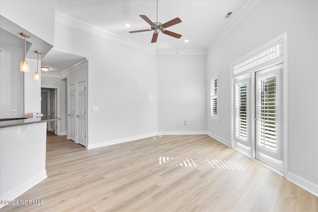 unfurnished living room featuring ornamental molding, ceiling fan, and light hardwood / wood-style floors