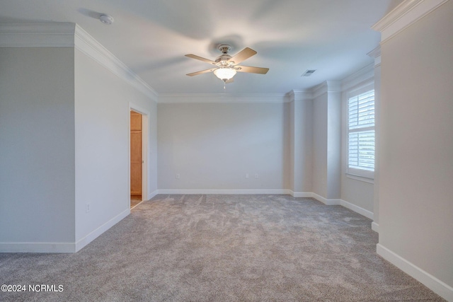 carpeted empty room featuring crown molding and ceiling fan