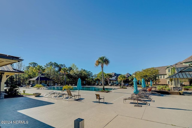 view of swimming pool featuring a gazebo and a patio