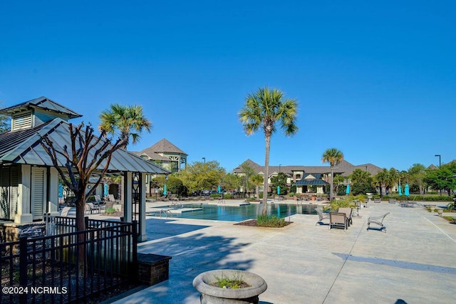 view of swimming pool with a gazebo and a patio area