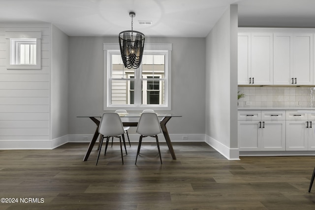 dining area featuring an inviting chandelier, dark hardwood / wood-style flooring, and plenty of natural light