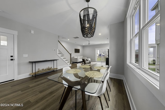 dining room featuring an inviting chandelier and dark wood-type flooring