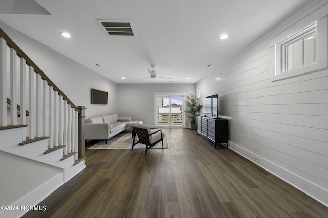 living room featuring dark hardwood / wood-style floors and ceiling fan