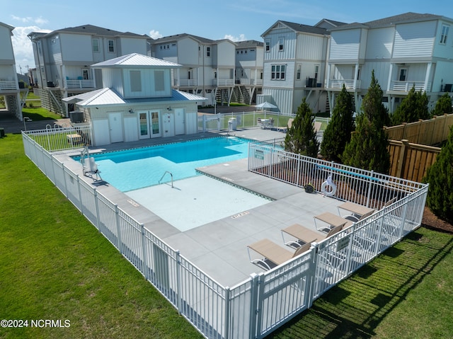 view of pool featuring a lawn and a patio area