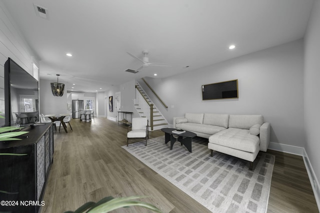 living room with wood-type flooring and ceiling fan