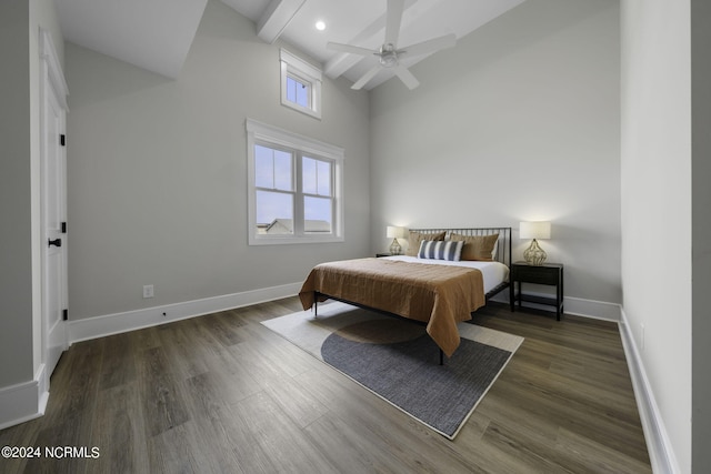 bedroom featuring a towering ceiling, beam ceiling, ceiling fan, and dark hardwood / wood-style flooring