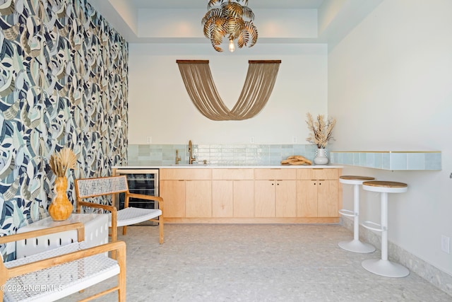 living area with wine cooler and sink