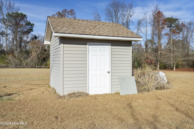 view of outbuilding with a yard