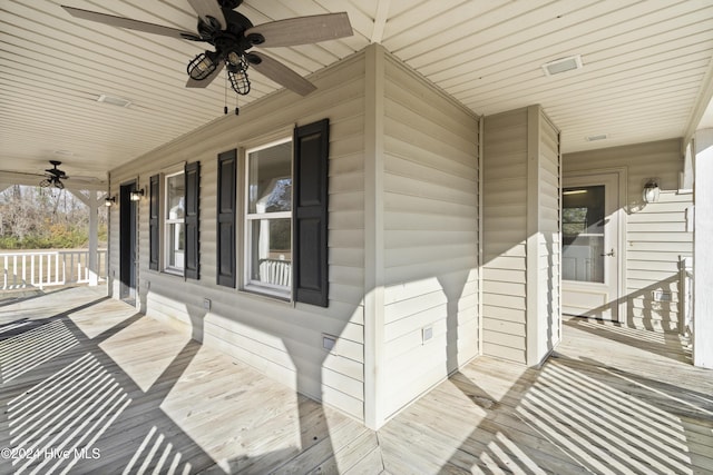 wooden terrace featuring ceiling fan and a porch