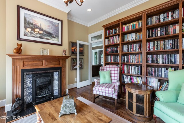 sitting room featuring ornamental molding and hardwood / wood-style floors