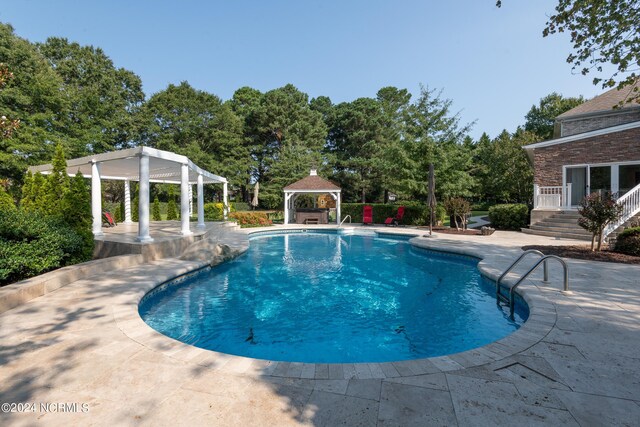 view of pool featuring a patio area, a pergola, and a gazebo