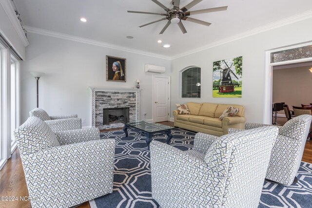 living room with crown molding, ceiling fan, an AC wall unit, and wood-type flooring