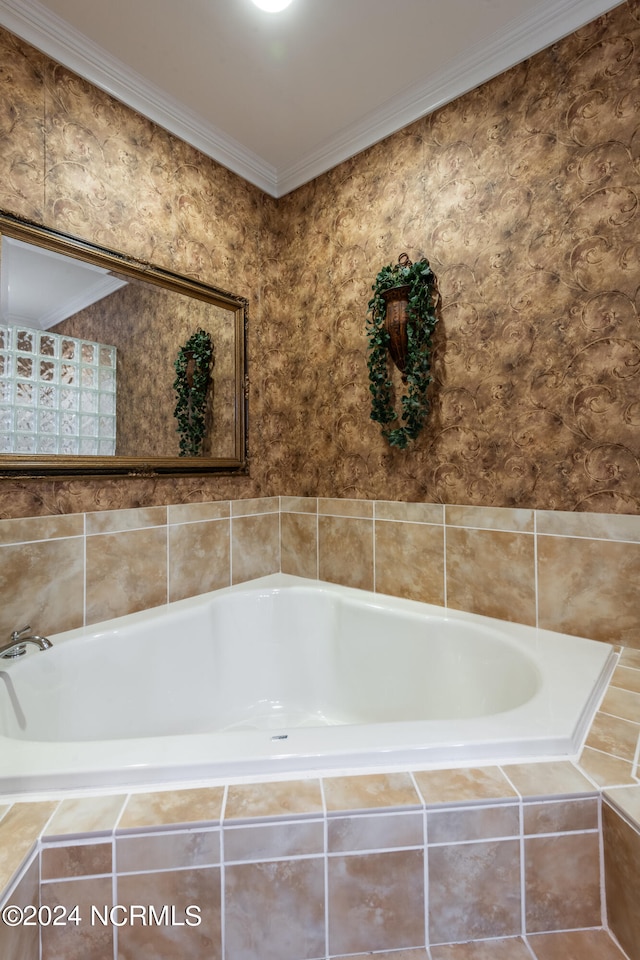 bathroom featuring ornamental molding and tiled bath