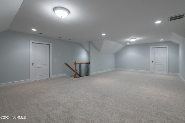 bonus room featuring light colored carpet and vaulted ceiling