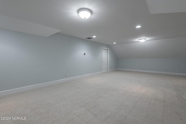 additional living space with lofted ceiling and light colored carpet