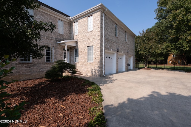 view of side of home featuring a garage