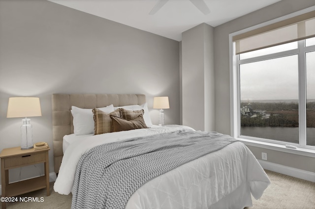 bedroom featuring a ceiling fan, carpet, and baseboards