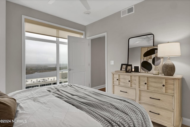 bedroom featuring a ceiling fan, visible vents, and baseboards