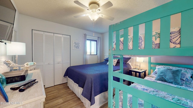 bedroom featuring a textured ceiling, ceiling fan, a closet, and wood-type flooring