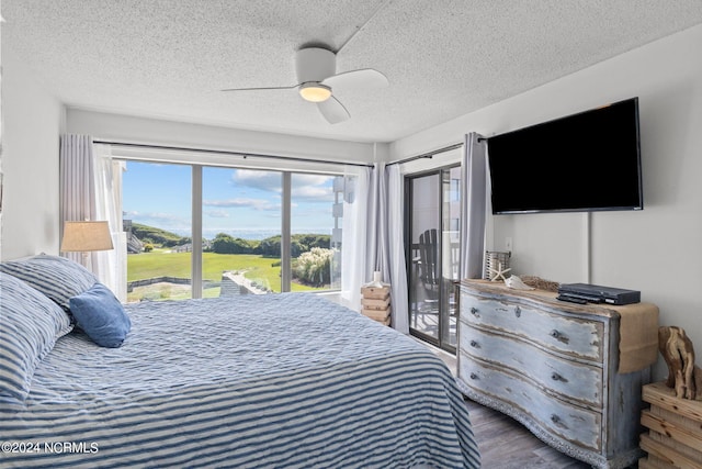 bedroom with a textured ceiling, access to exterior, ceiling fan, and hardwood / wood-style floors