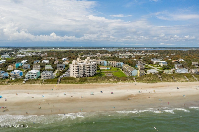 birds eye view of property featuring a water view and a beach view