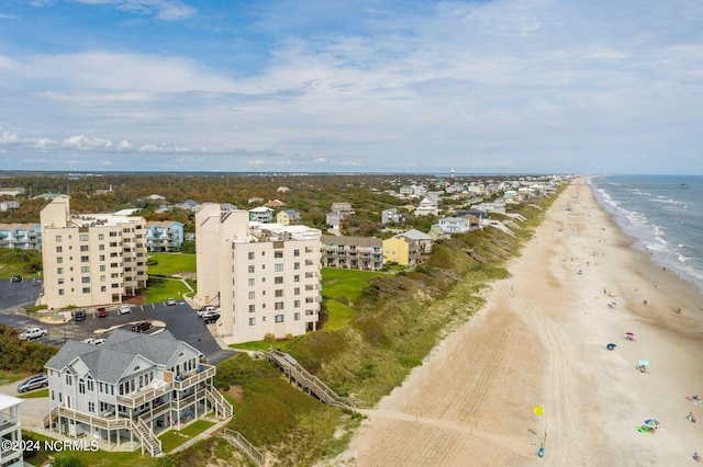 birds eye view of property featuring a beach view and a water view