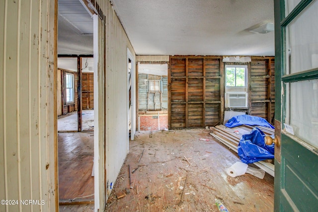 interior space featuring cooling unit and a textured ceiling