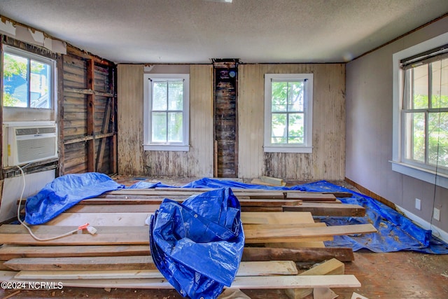 misc room featuring cooling unit and a textured ceiling