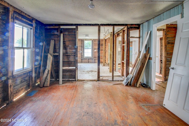 misc room featuring wood-type flooring and a textured ceiling