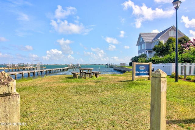 view of yard with a water view and a dock