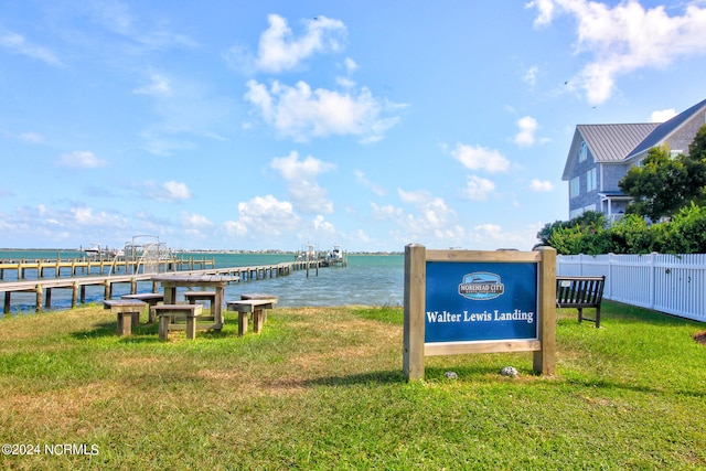 dock area featuring a lawn and a water view