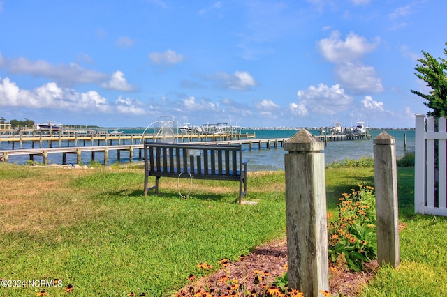 dock area featuring a water view and a lawn