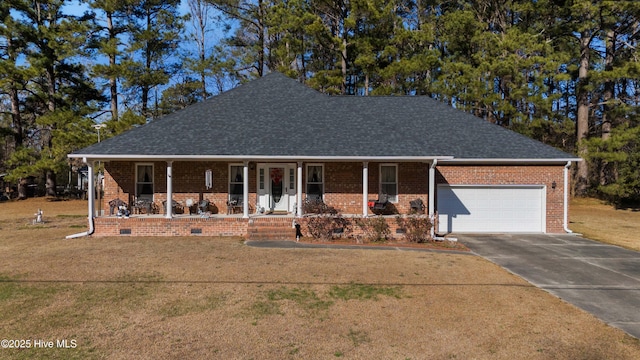 view of front of home with covered porch, a front lawn, and a garage