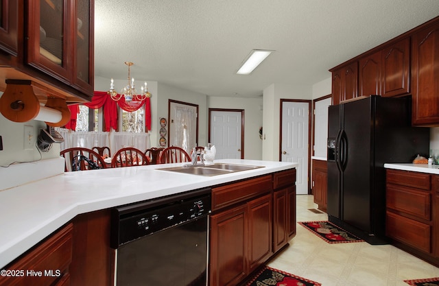 kitchen with a textured ceiling, decorative light fixtures, black appliances, an inviting chandelier, and sink