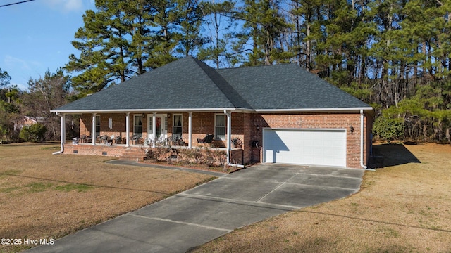 view of front of home with a front yard, a garage, and covered porch