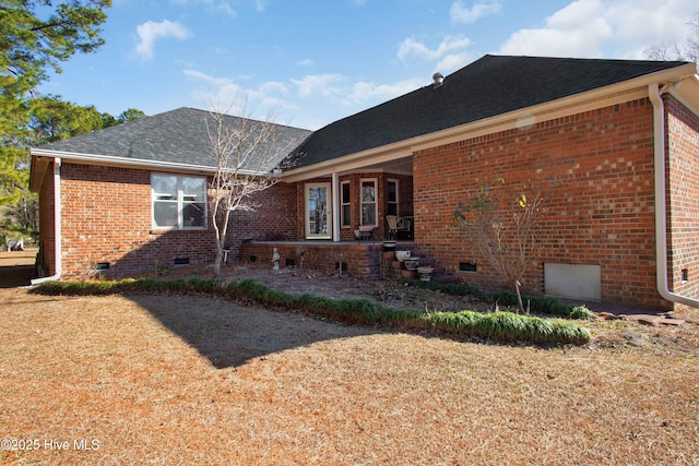 rear view of property featuring a lawn