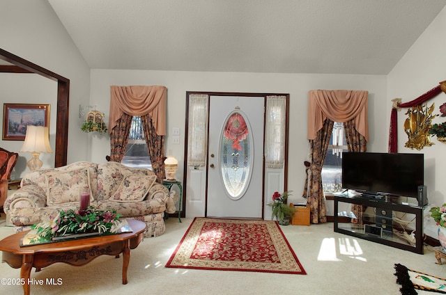 carpeted entryway featuring vaulted ceiling