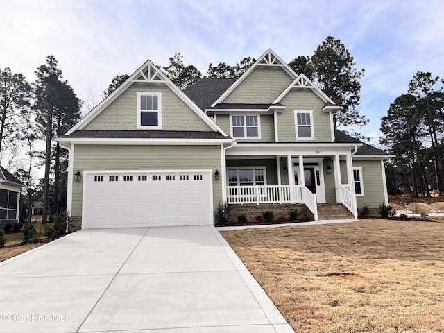 craftsman-style home featuring a garage, a front yard, and covered porch