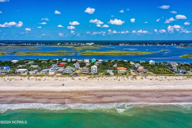 birds eye view of property featuring a beach view and a water view