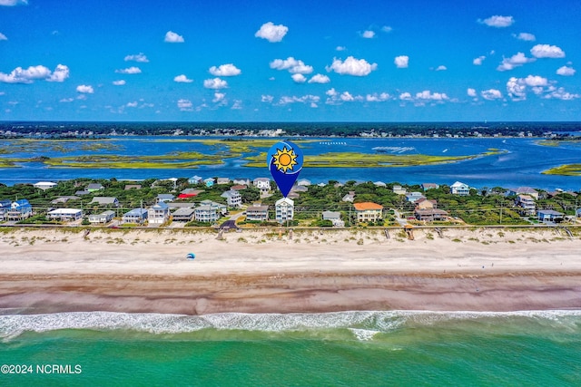 drone / aerial view with a water view and a view of the beach