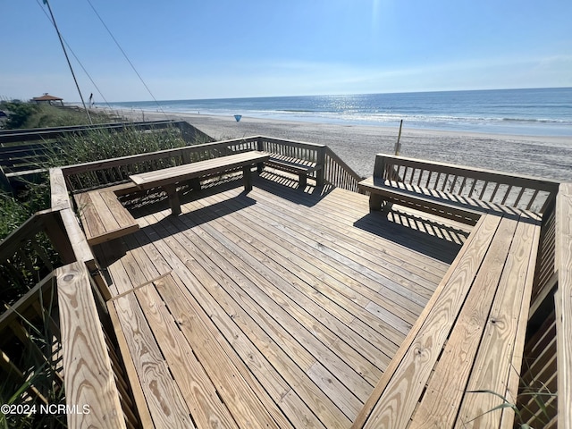 view of community featuring a water view and a beach view