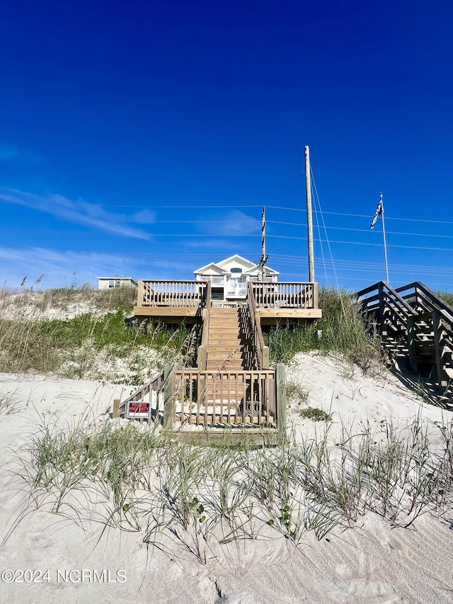 view of property's community with a wooden deck and stairs