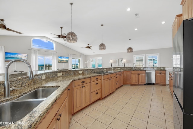 kitchen featuring stainless steel appliances, light tile patterned flooring, a sink, and ceiling fan