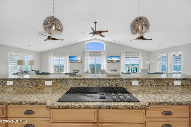 kitchen with a ceiling fan, open floor plan, vaulted ceiling, black electric cooktop, and light brown cabinets