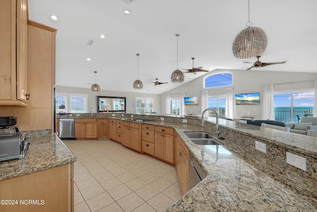 kitchen with light tile patterned floors, a sink, a ceiling fan, stainless steel dishwasher, and light brown cabinetry