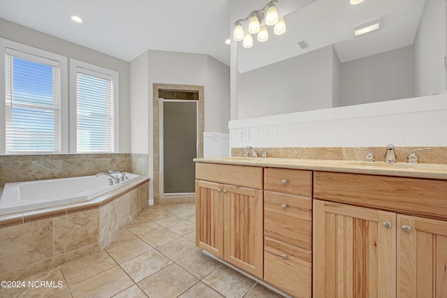 bathroom featuring a stall shower, visible vents, a garden tub, tile patterned flooring, and a sink