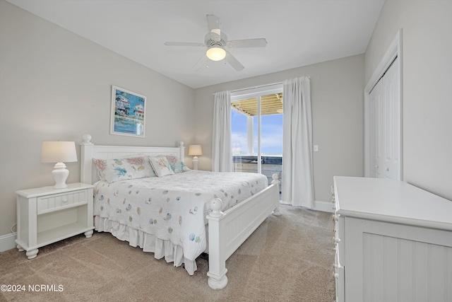 bedroom with access to exterior, light colored carpet, ceiling fan, and baseboards