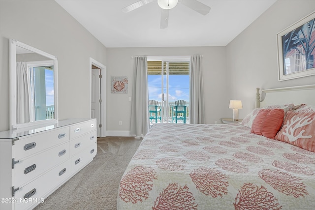 bedroom featuring access to exterior, light colored carpet, baseboards, and a ceiling fan