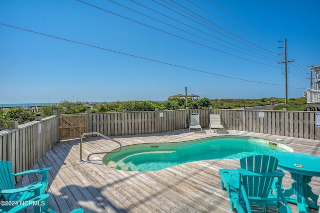 view of pool with a fenced in pool and a wooden deck